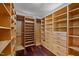 Spacious walk-in closet with custom wood shelving, drawers, and hanging rods for ample storage at 5401 Friends School Rd, Durham, NC 27705