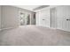 Finished basement featuring carpeted flooring, a sliding glass door, and a closet for storage at 5505 Crabtree Park Ct, Raleigh, NC 27612