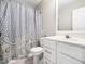 Cozy bathroom features a patterned shower curtain and a single sink vanity at 5505 Crabtree Park Ct, Raleigh, NC 27612
