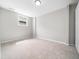 Empty bedroom featuring carpeted floor, neutral wall, and single window at 5505 Crabtree Park Ct, Raleigh, NC 27612