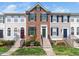 Charming brick-front townhome featuring a well-manicured lawn and color-coordinated shutters at 5505 Crabtree Park Ct, Raleigh, NC 27612