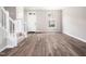 Bright entryway featuring hardwood floors, a window, and staircase with white banister at 5505 Crabtree Park Ct, Raleigh, NC 27612