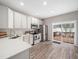 Well-lit kitchen boasts sleek, stainless steel appliances, ample storage, and a sliding glass door to the deck at 5505 Crabtree Park Ct, Raleigh, NC 27612