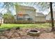Private backyard oasis with a fire pit, deck area for outdoor entertaining, and a lush green lawn at 600 Old Farm Rd Rd, Graham, NC 27253