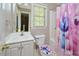 Bathroom with vanity, mirror, toilet, and shower with decorated shower curtain at 600 Old Farm Rd Rd, Graham, NC 27253
