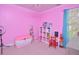 Bright pink bedroom with organized white shelving and desk, ready for playful learning and cozy rest at 600 Old Farm Rd Rd, Graham, NC 27253