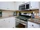 Kitchen featuring granite countertops, stainless steel appliances, and neutral backsplash at 600 Old Farm Rd Rd, Graham, NC 27253