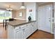Kitchen area featuring granite counters, wooden floors, white cabinets, and dining area at 600 Old Farm Rd Rd, Graham, NC 27253
