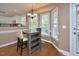 Kitchen featuring wood floors, modern light fixture, breakfast table, and stainless appliances at 600 Old Farm Rd Rd, Graham, NC 27253