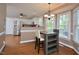 Eat-in kitchen with modern appliances, breakfast bar, stainless steel refrigerator, and hardwood floors at 600 Old Farm Rd Rd, Graham, NC 27253