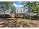 Well-maintained backyard featuring a spacious wooden deck, lush lawn, and mature trees, perfect for outdoor enjoyment at 613 Holly Thorn, Holly Springs, NC 27540