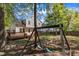 Backyard with wooden deck and swing set, perfect for outdoor fun and relaxation in a serene setting at 613 Holly Thorn, Holly Springs, NC 27540