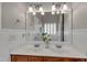 Bathroom with a double sink vanity, large mirror, and decorative lighting at 613 Holly Thorn, Holly Springs, NC 27540
