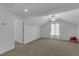 Bonus room with neutral carpet, window, and ceiling fan at 613 Holly Thorn, Holly Springs, NC 27540