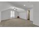 Spacious bonus room with neutral carpet, ceiling fan, and natural light from a window at 613 Holly Thorn, Holly Springs, NC 27540