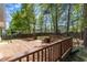 Expansive wooden deck offers plenty of room for outdoor living and entertaining in a private backyard setting at 613 Holly Thorn, Holly Springs, NC 27540
