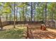 A spacious deck provides ample space for outdoor enjoyment and entertaining amidst a backdrop of lush greenery at 613 Holly Thorn, Holly Springs, NC 27540