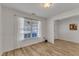 Dining room with hardwood floors, a big window and freshly painted walls, ready for personalization at 613 Holly Thorn, Holly Springs, NC 27540