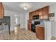 Kitchen with wooden cabinets, granite countertops, hardwood floors and modern appliances, ready for meal preperation at 613 Holly Thorn, Holly Springs, NC 27540