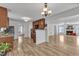 Open kitchen with wooden cabinets, granite countertops, and seamless flow to the living room at 613 Holly Thorn, Holly Springs, NC 27540