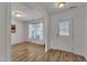Bright living room boasts hardwood floors, large front door and fresh white walls, ready for personalization at 613 Holly Thorn, Holly Springs, NC 27540