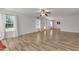 Light-filled living room with hardwood floors, ceiling fan and many windows overlooking the backyard at 613 Holly Thorn, Holly Springs, NC 27540