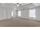 Spacious main bedroom with neutral carpet, a tray ceiling, and lots of natural light at 613 Holly Thorn, Holly Springs, NC 27540