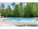 Bright community pool with stainless steel ladder and in-pool logo at 613 Holly Thorn, Holly Springs, NC 27540