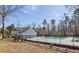 Community pool with black metal fence and mature trees surrounding the area at 613 Holly Thorn, Holly Springs, NC 27540