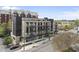 Contemporary mid-rise with mixed brick facade, balconies, and street-level retail spaces at 615 W Peace St # 201, Raleigh, NC 27605