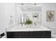 Double sink bathroom with contemporary lighting and white countertops at 615 W Peace St # 201, Raleigh, NC 27605