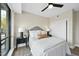 Comfortable bedroom with cozy bedding, dark furniture, and serene street views from a window at 615 W Peace St # 201, Raleigh, NC 27605