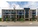 Modern apartment building showcases brick facade, dark trim, and private balconies at 615 W Peace St # 201, Raleigh, NC 27605