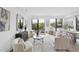 Bright living room with neutral decor, large windows, modern furniture, and hardwood floors at 615 W Peace St # 201, Raleigh, NC 27605