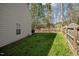 A fenced backyard showing the lawn with tall trees in the background at 616 Branchview Dr, Durham, NC 27713