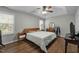 Bright bedroom features a tray ceiling, wood flooring, and two windows for natural light at 616 Branchview Dr, Durham, NC 27713