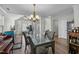 Dining room featuring a chandelier, table with chairs, piano, and is adjacent to the living room at 616 Branchview Dr, Durham, NC 27713