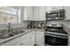Bright kitchen featuring white cabinets, stainless steel appliances, and light granite countertops at 616 Branchview Dr, Durham, NC 27713