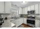 Bright kitchen featuring white cabinets, stainless steel appliances, and light granite countertops at 616 Branchview Dr, Durham, NC 27713