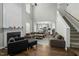 Open floor plan with living room, fireplace, staircase, and kitchen in the background at 616 Branchview Dr, Durham, NC 27713