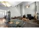 Large living room with high ceilings, fireplace, and staircase leading to the upper level at 616 Branchview Dr, Durham, NC 27713