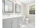 Bathroom with double vanity, a window, and modern fixtures at 6216 Valley Estates Dr, Raleigh, NC 27612