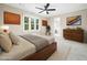 Primary bedroom features a ceiling fan, a large window, and neutral carpet at 6216 Valley Estates Dr, Raleigh, NC 27612