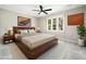 Bedroom features a ceiling fan, a large window, and neutral carpet at 6216 Valley Estates Dr, Raleigh, NC 27612