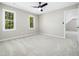 Spacious bedroom with two windows and a ceiling fan at 6216 Valley Estates Dr, Raleigh, NC 27612