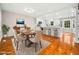 Elegant dining room and kitchen with hardwood floors, white cabinets, and plenty of natural light at 6216 Valley Estates Dr, Raleigh, NC 27612