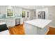 Bright kitchen featuring a white island, stainless steel appliances, and sleek modern cabinetry with hardwood floors at 6216 Valley Estates Dr, Raleigh, NC 27612