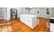 Bright modern kitchen with a large center island, stainless steel appliances, and hardwood floors at 6216 Valley Estates Dr, Raleigh, NC 27612