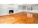 Spacious living room features a fireplace, built-in shelves, hardwood floors, and lots of natural light at 6216 Valley Estates Dr, Raleigh, NC 27612