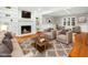 Cozy living room with a fireplace, built-in bookshelves, hardwood floors, and comfortable seating at 6216 Valley Estates Dr, Raleigh, NC 27612